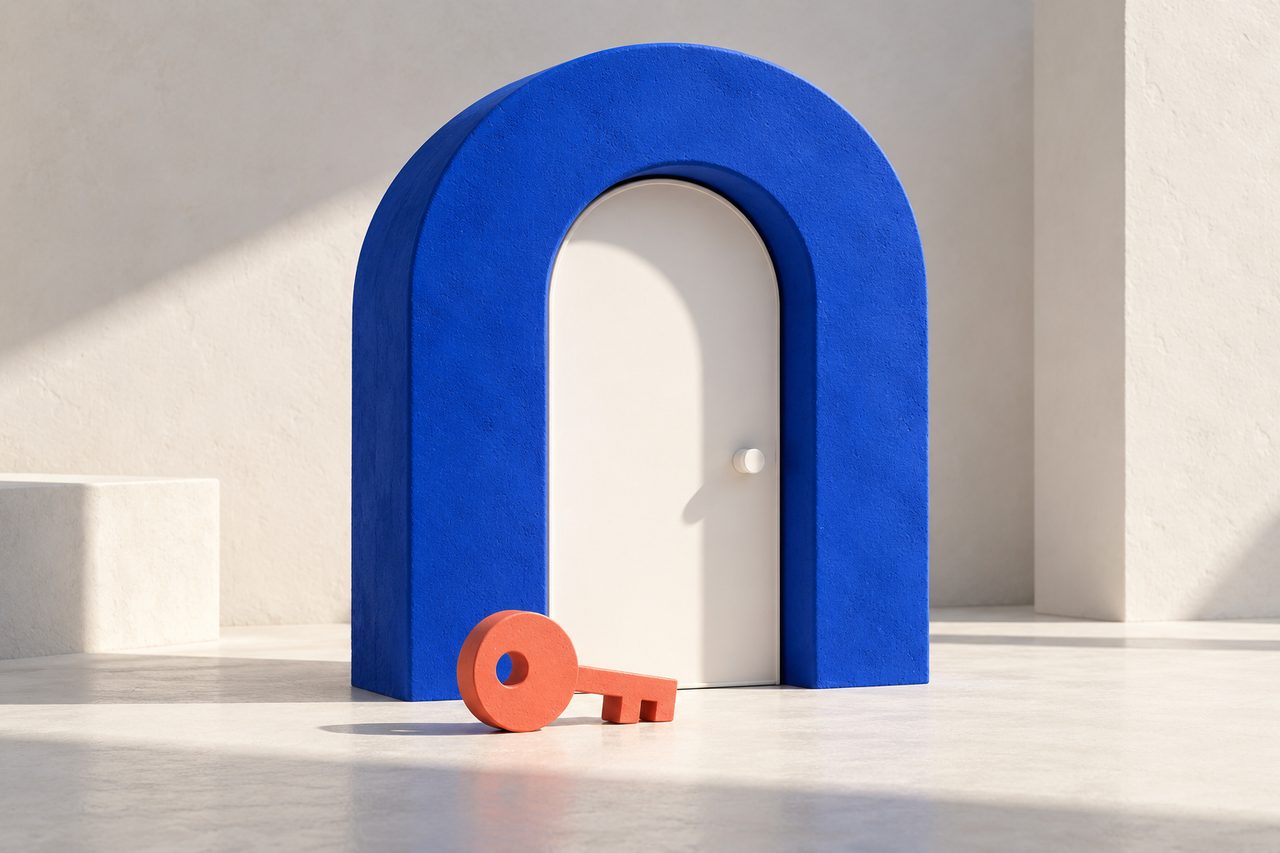 A thick blue arch around a white door, with a coral key on the floor in front of it