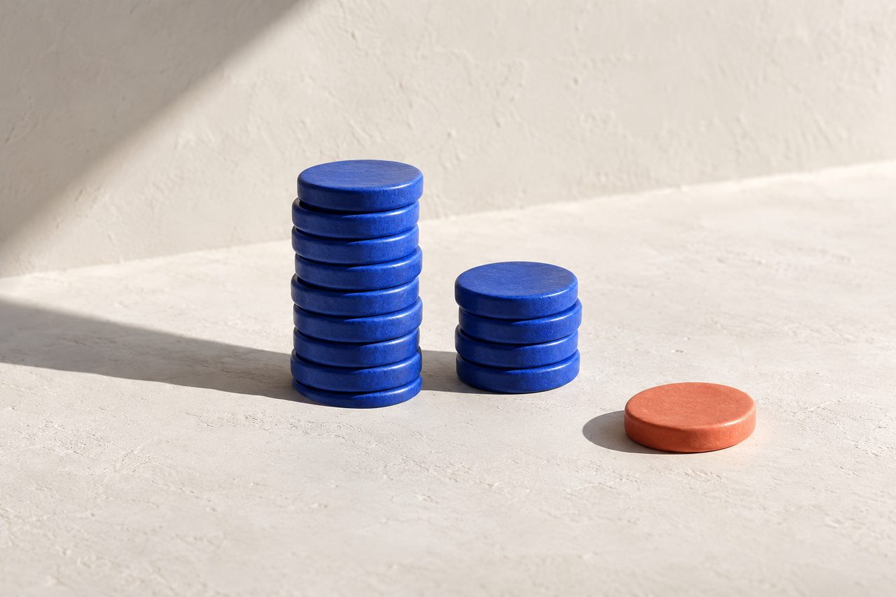Two stacks of blue discs, one much taller than the other, with a single coral disc set apart