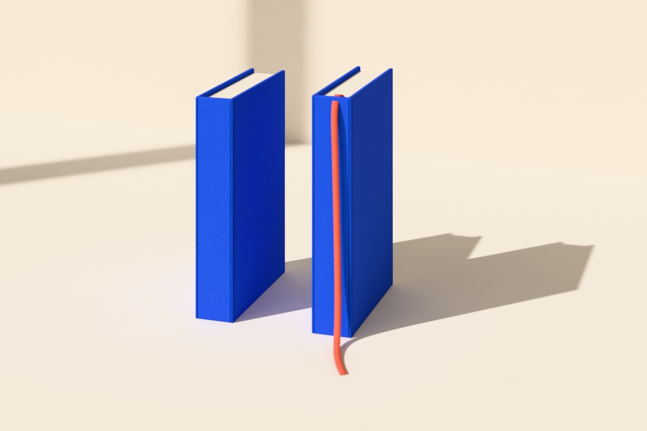 Two cobalt books standing upright with a gap between them, and a coral bookmark ribbon trailing from the second