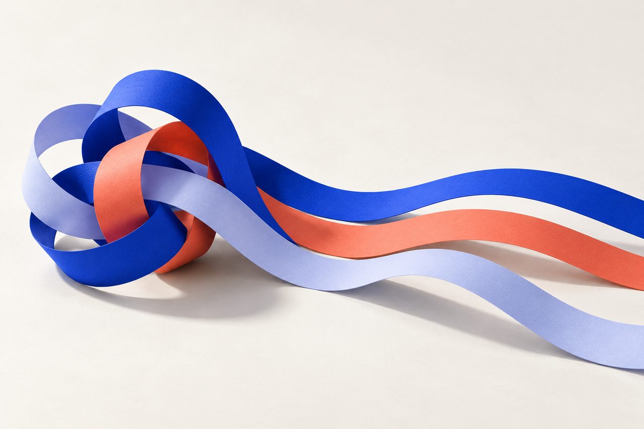 Cobalt, coral and lilac paper ribbons untangling into one clear path